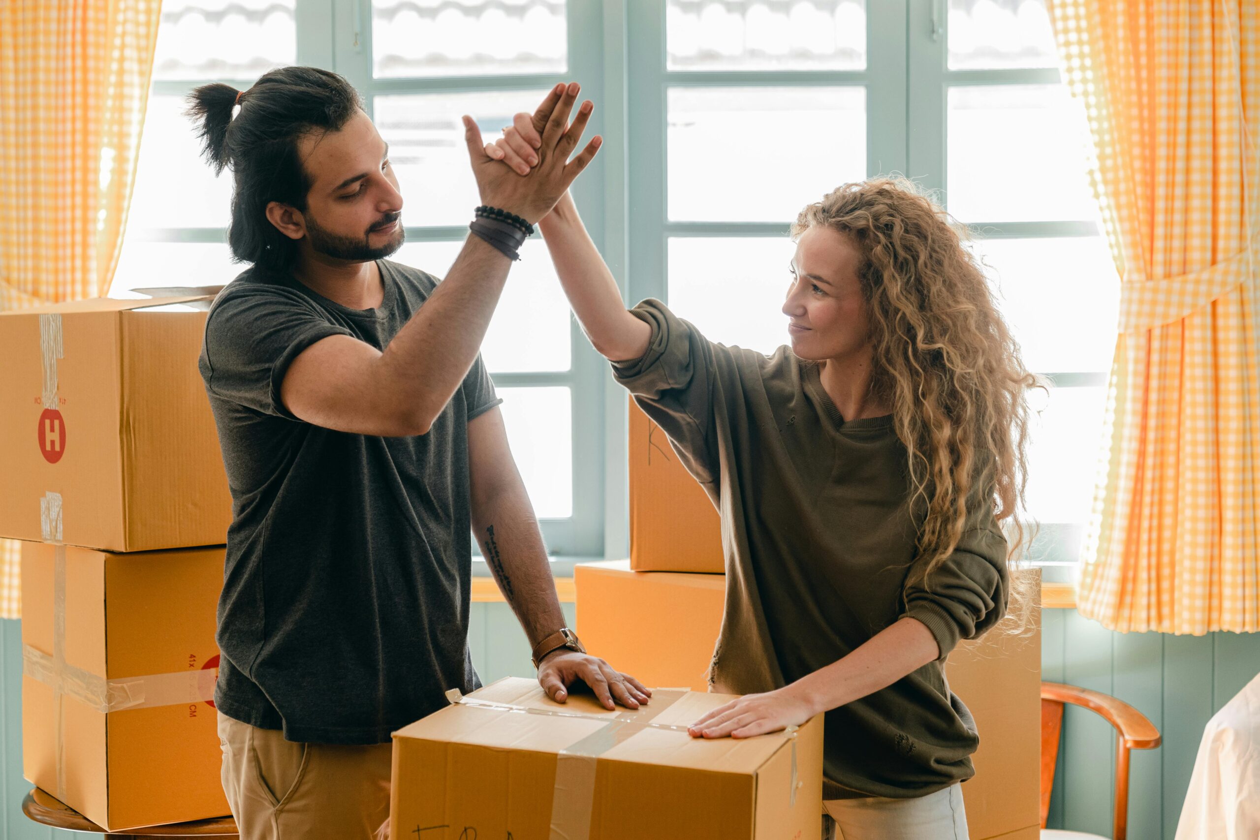 couple high fiving while renting in israel