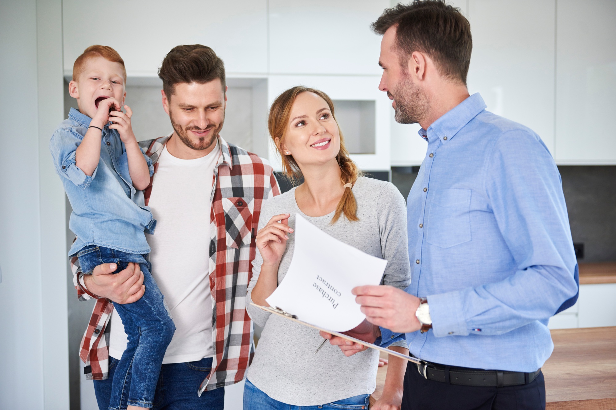 Family and real estate agent talking in new apartment