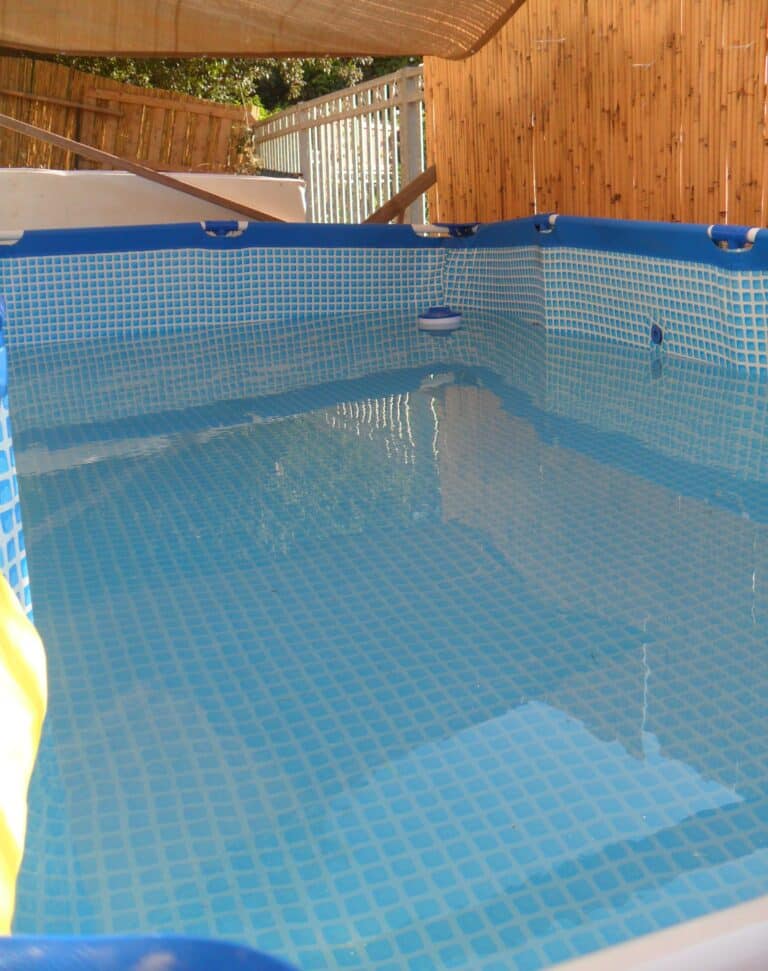 pool interior with blue tiles and metal frame