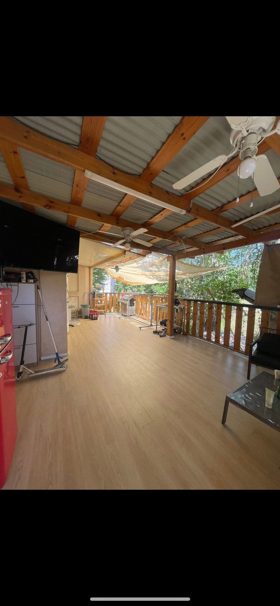 Wooden patio with furniture and outdoor seating area.