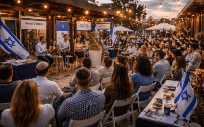 People sitting in chairs at an outdoor event space.