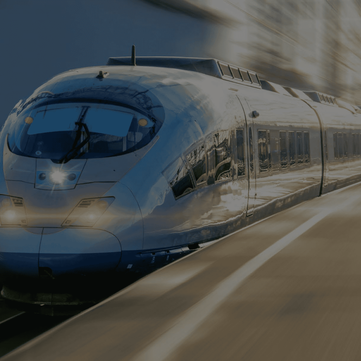 High speed train traveling on train tracks quickly.