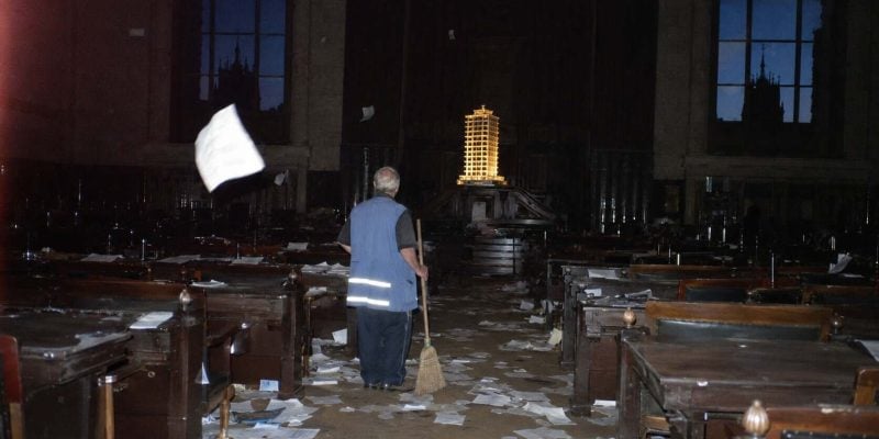 abandoned courtroom with glowing model tower in israel