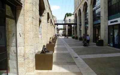 Shoppers walk along the open-air Mamilla Avenue mall in Jerusalem, built and owned by the Alrov group