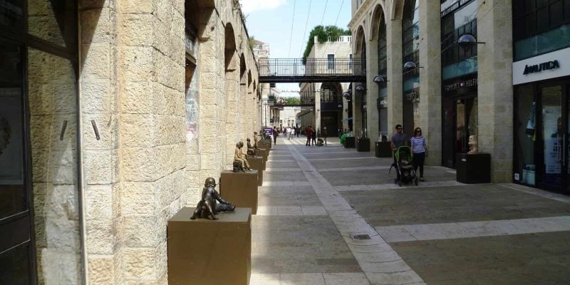 Shoppers walk along the open-air Mamilla Avenue mall in Jerusalem, built and owned by the Alrov group