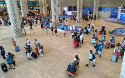 Anglo families arriving at Ben Gurion Airport with luggage during relocation to Israel