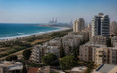 Modern apartment buildings near the Ashdod coastline with the port area in the distance