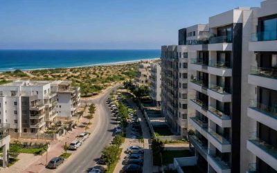 Modern apartment buildings near the Ashkelon coastline with residential streets and the sea in the background