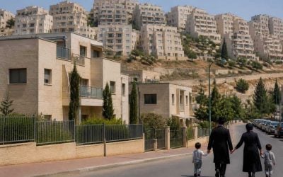 Residential apartment buildings in Beit Shemesh with hillside neighborhoods in the background