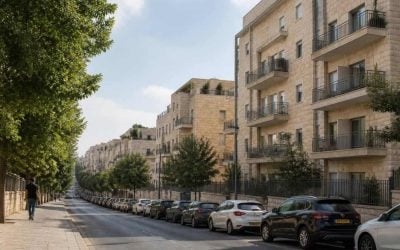 Residential apartment buildings on a quiet Jerusalem street with pedestrians and trees