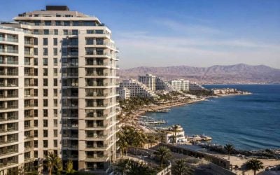 Modern apartment buildings near the Eilat waterfront with beaches and resort hotels in the background