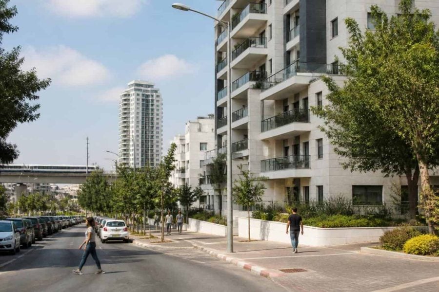 Modern apartment buildings and a tree-lined urban street in Holon near central Israel transit corridors