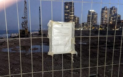 construction site at twilight through fence in israel