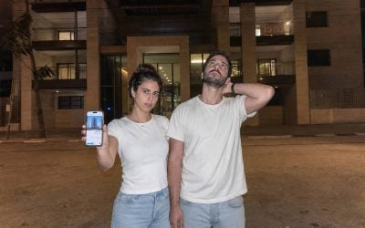 couple facing new building at night