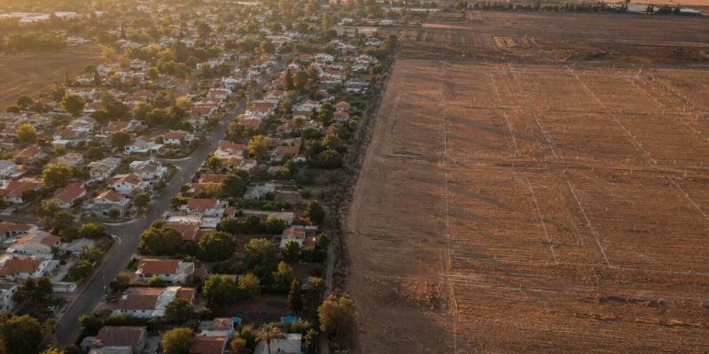 golden hour aerial of israel town expansion