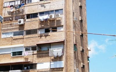 Haifa apartment block whose balconies have been added and closed in with different railings, awnings and window frames