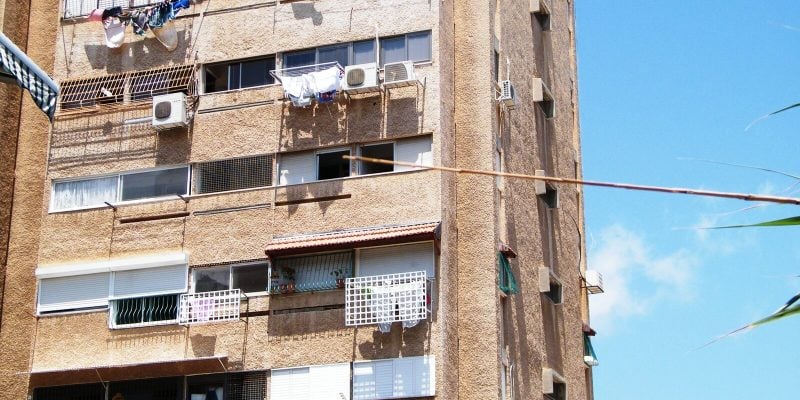 Haifa apartment block whose balconies have been added and closed in with different railings, awnings and window frames