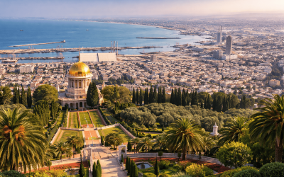 Panoramic view of Haifa overlooking the Bahá’í Gardens, port, and Mediterranean coastline at dusk