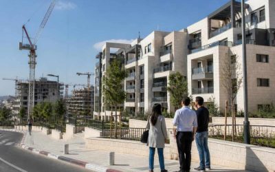 Israeli apartment buildings and construction cranes in a growing urban neighborhood
