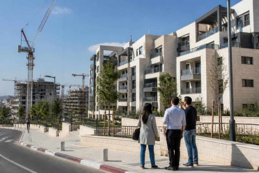 Israeli apartment buildings and construction cranes in a growing urban neighborhood