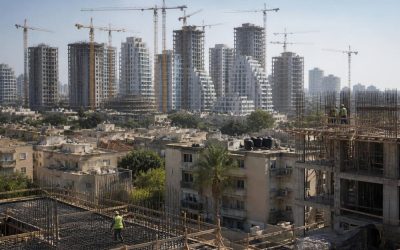 Residential construction cranes and apartment towers in an Israeli city neighborhood