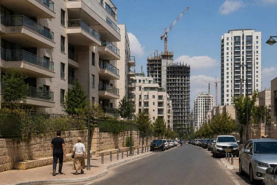 Modern apartment buildings in Israel with pedestrians and residential streets in a changing housing market