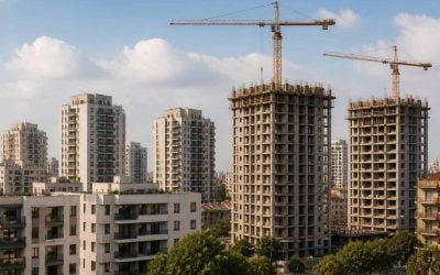 Construction cranes over new apartment buildings in an Israeli city