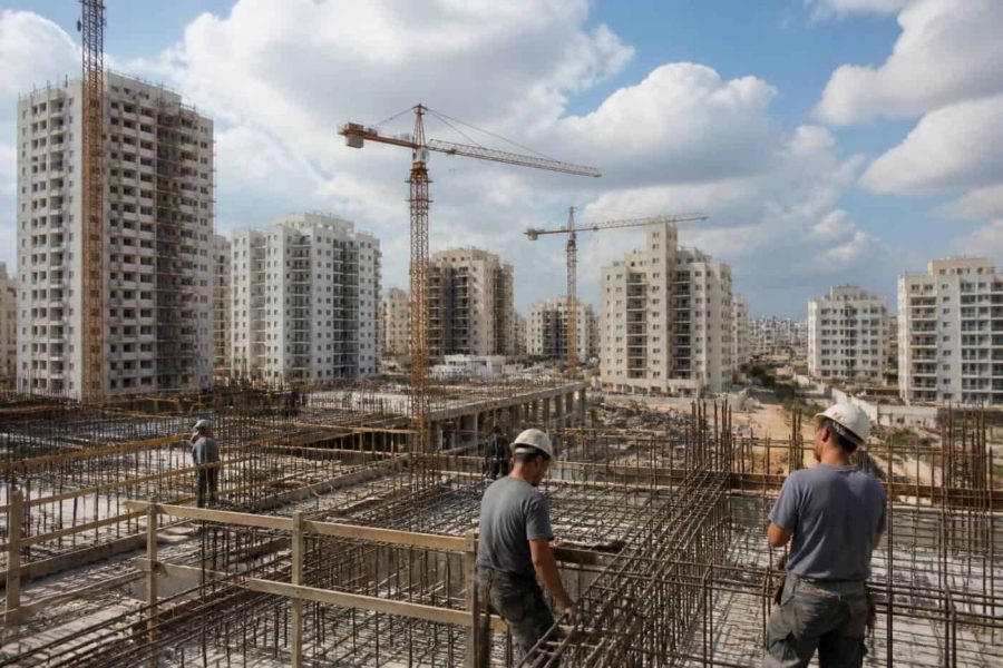 Residential apartment construction in an Israeli city with cranes and modern buildings