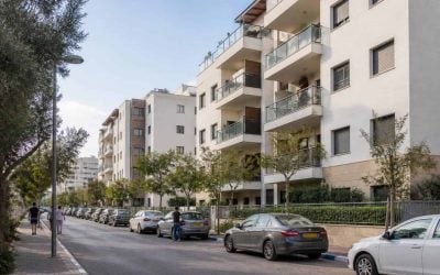 Modern apartment buildings and a tree-lined street in Kfar Saba