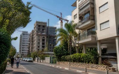 Apartment buildings and construction cranes in a residential Israeli neighborhood undergoing urban renewal
