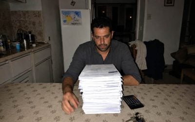 man facing paperwork in the kitchen