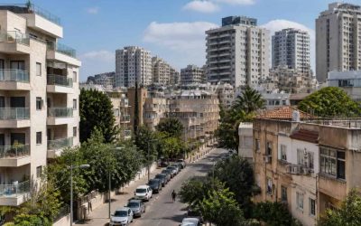 Residential apartment buildings in an Israeli coastal city with modern and older housing blocks