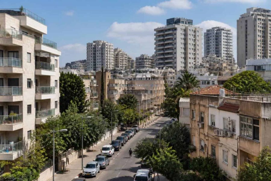 Residential apartment buildings in an Israeli coastal city with modern and older housing blocks
