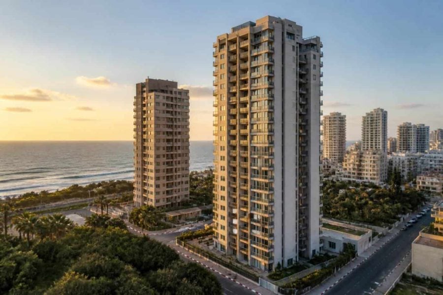 Modern apartment buildings along the Netanya coastline at sunset with Mediterranean Sea views