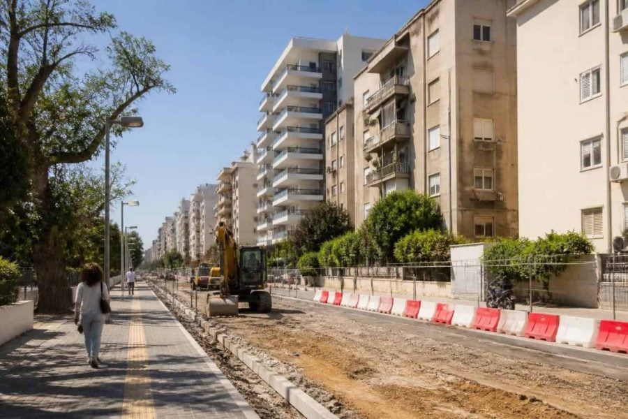 Construction crews and apartment buildings in a Netanya neighborhood undergoing urban renewal