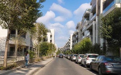 Modern apartment buildings and tree-lined street in Rehovot, Israel