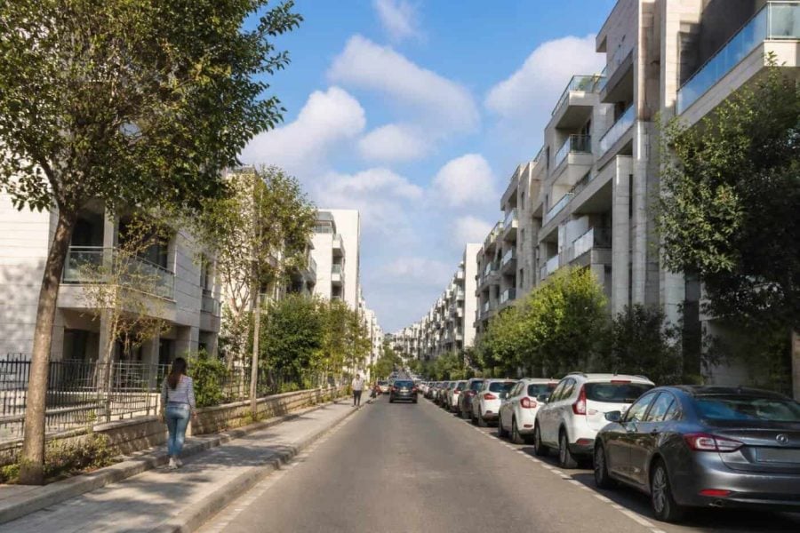 Modern apartment buildings and tree-lined street in Rehovot, Israel