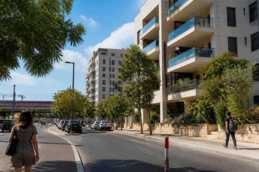 Modern apartment buildings and a tree-lined street in Rehovot, Israel