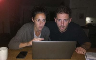 shocked expressions in dim light in israel starring at a laptop