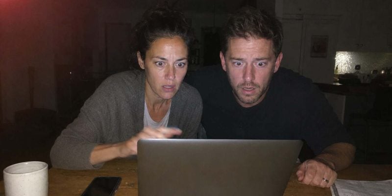 shocked expressions in dim light in israel starring at a laptop