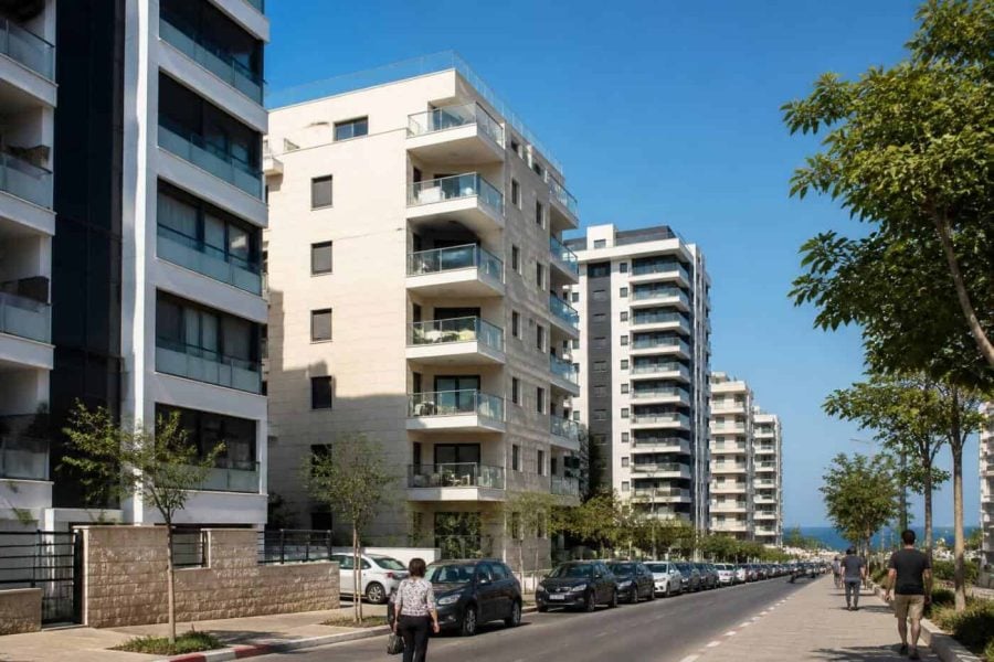 Modern apartment buildings along the Israeli coast with residential balconies and city streets below