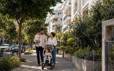 Family walking near established Israeli neighborhood amenities and residential buildings