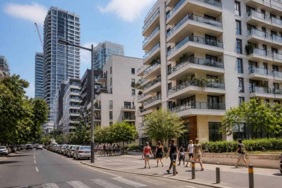 Modern apartment buildings and a busy street in Tel Aviv viewed in daylight