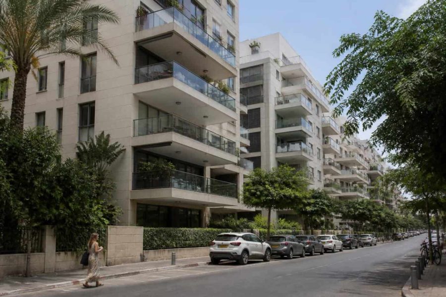 Modern Tel Aviv apartment buildings viewed from a quiet residential street