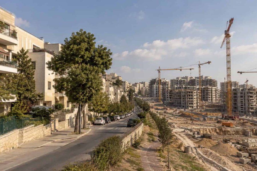 Contrasting Israeli residential street and new construction area showing a split housing market