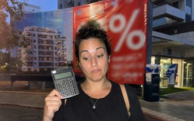 urban night sale with calculator and banner - israel commercial real estate