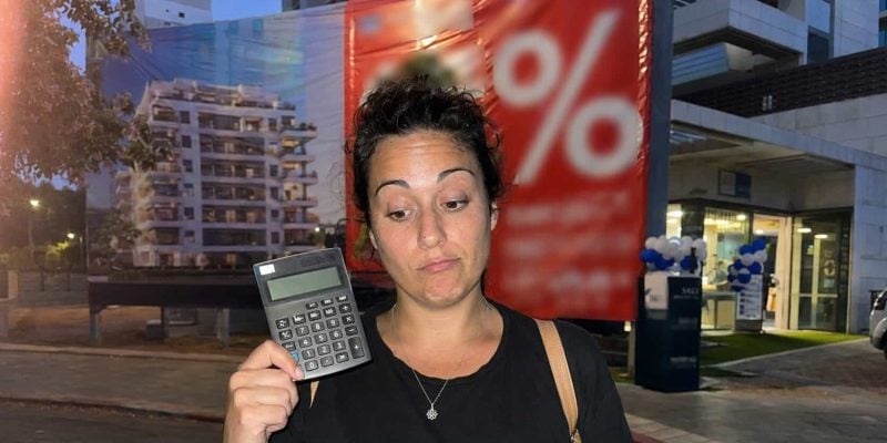 urban night sale with calculator and banner - israel commercial real estate