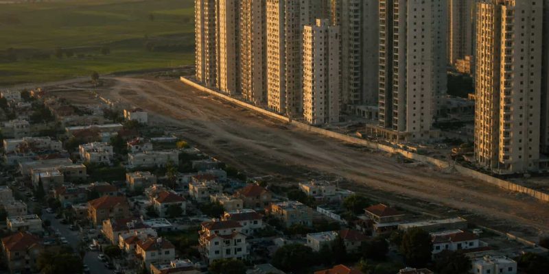 urban sprawl meets open fields at dusk