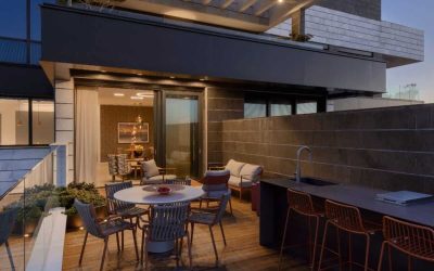 Modern outdoor living space with dining and kitchen area.