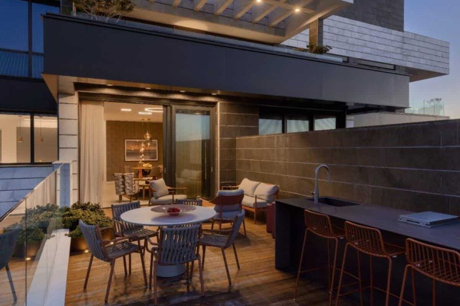 Modern outdoor living space with dining and kitchen area.